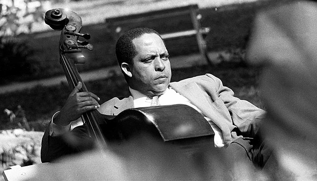Cachao as a younger man with an upright bass and wearing a suit